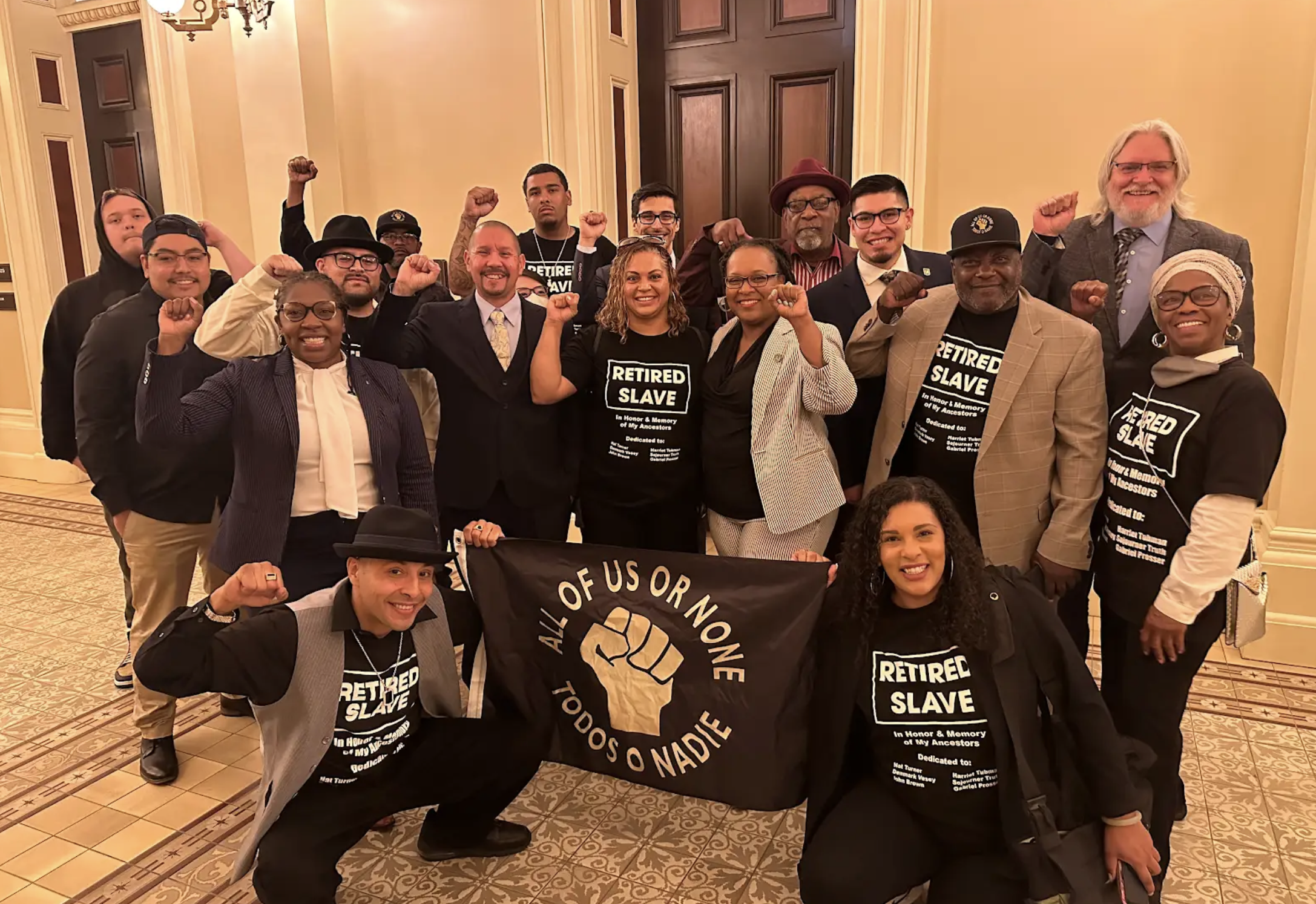 Staff members of Legal Services for Prisoners with Children pose for a photo inside of the California State Capitol in Sacramento.
